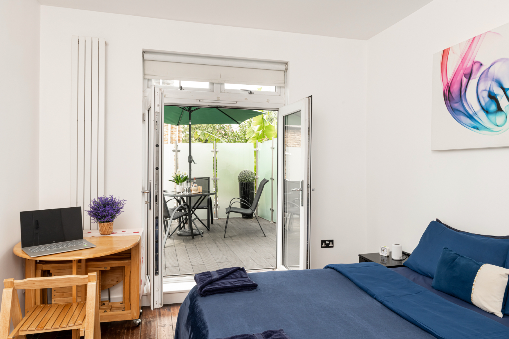 Garden-view bedroom opening onto a private terrace