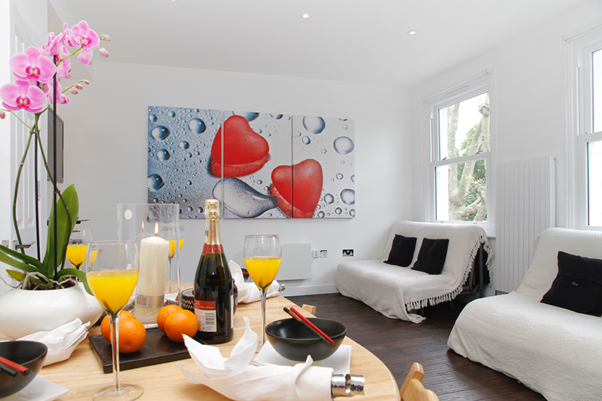 Bright open-plan living room with breakfast laid out